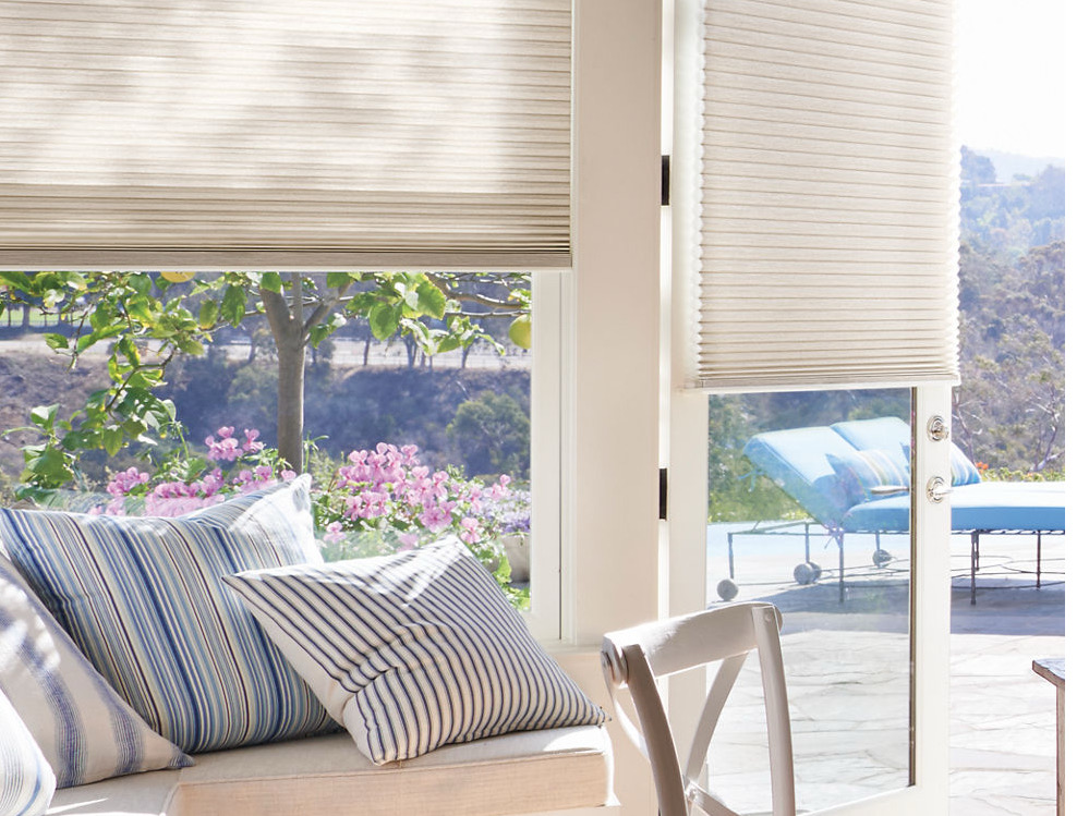 Sunlit seating area with honeycomb shades