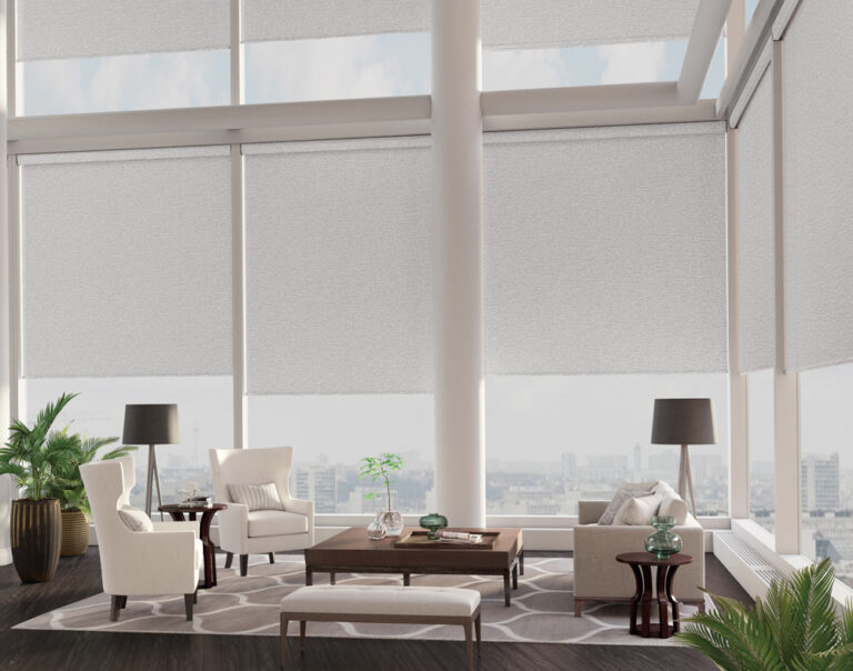 Light gray roller shades on tall corner windows in a bright modern living room with white furniture